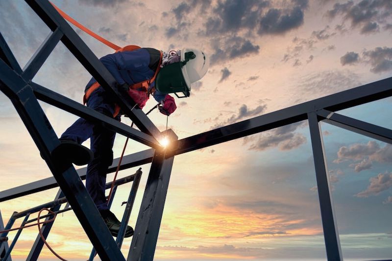 welder working at height with fall protection